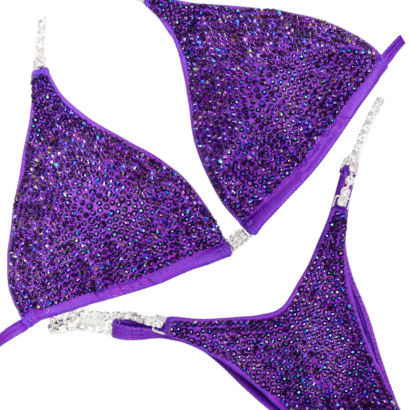 Introducing the Victorious Violet Radiance: a Hologram Purple competition suit adorned with Chrome Purple AB and Violet crystals! 💜💎 Stand out on stage with its shimmering elegance and powerful presence. Perfect for showcasing strength and style! #BodybuildingSuit #CompetitionReady #VictoriousVioletRadiance