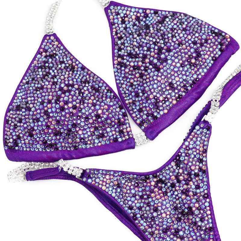 Andrea's Lilac Radiance, the ultimate competition suit for NPC Bikini or Wellness Athletes. Designed with Andrea Hrenko, it exudes elegance with light and dark shades of purple. Crafted for peak performance and style, it's the perfect blend of beauty and strength. Flaunt your confidence on stage with Andrea's Lilac Radiance.