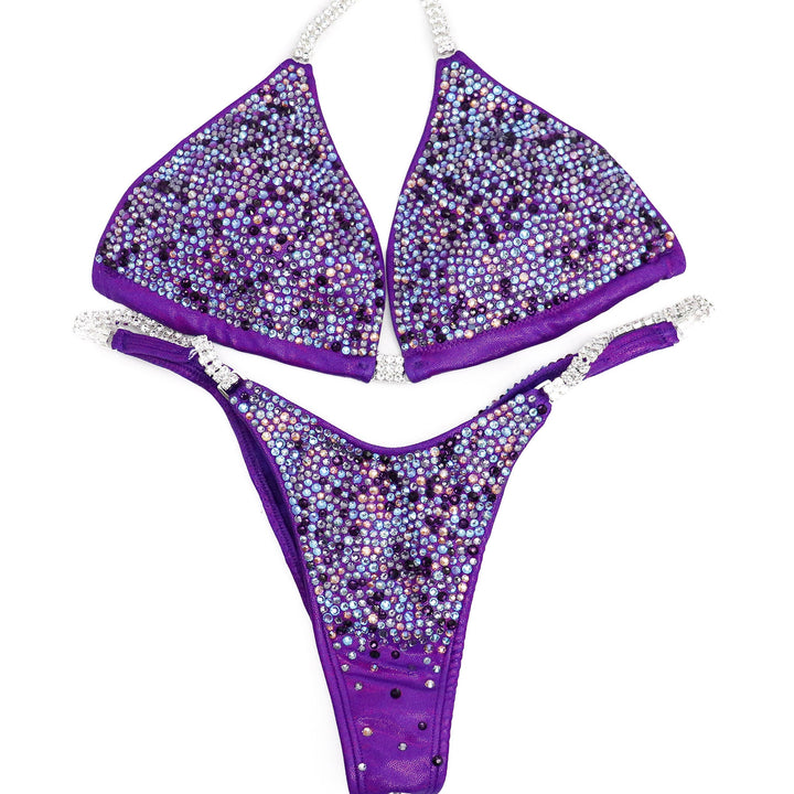 Andrea's Lilac Radiance, the ultimate competition suit for NPC Bikini or Wellness Athletes. Designed with Andrea Hrenko, it exudes elegance with light and dark shades of purple. Crafted for peak performance and style, it's the perfect blend of beauty and strength. Flaunt your confidence on stage with Andrea's Lilac Radiance.