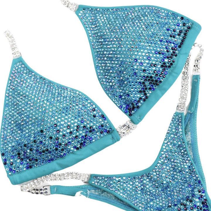 Aqua Pro Gradient, the pinnacle of elegance for female athletes. This crystal competition suit boasts stunning aqua and blue tones, designed to captivate on stage. Elevate your performance with unparalleled style and confidence.