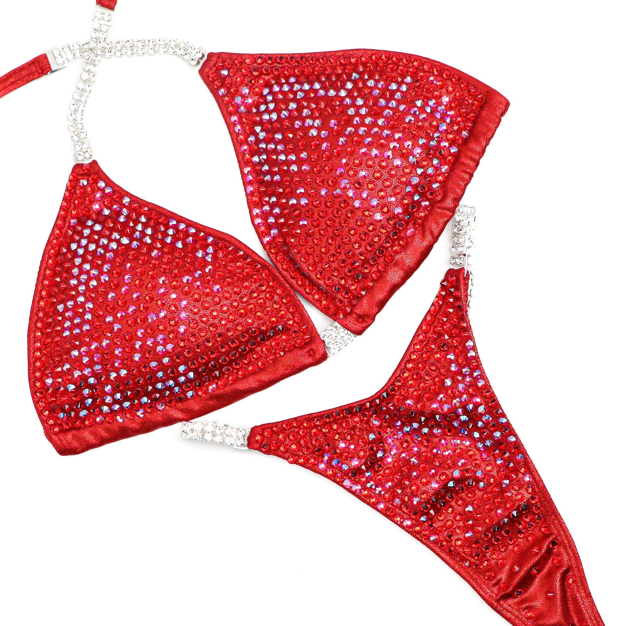 Introducing Ashley K's Cherry Bomb Trinity, inspired by Ashley Kaltwasser's iconic suit at the 2023 Denver Mile High. Radiating with vibrant red hues, this suit ensures you command attention on stage. Elevate your performance with its striking design, a must-have for serious competitors.