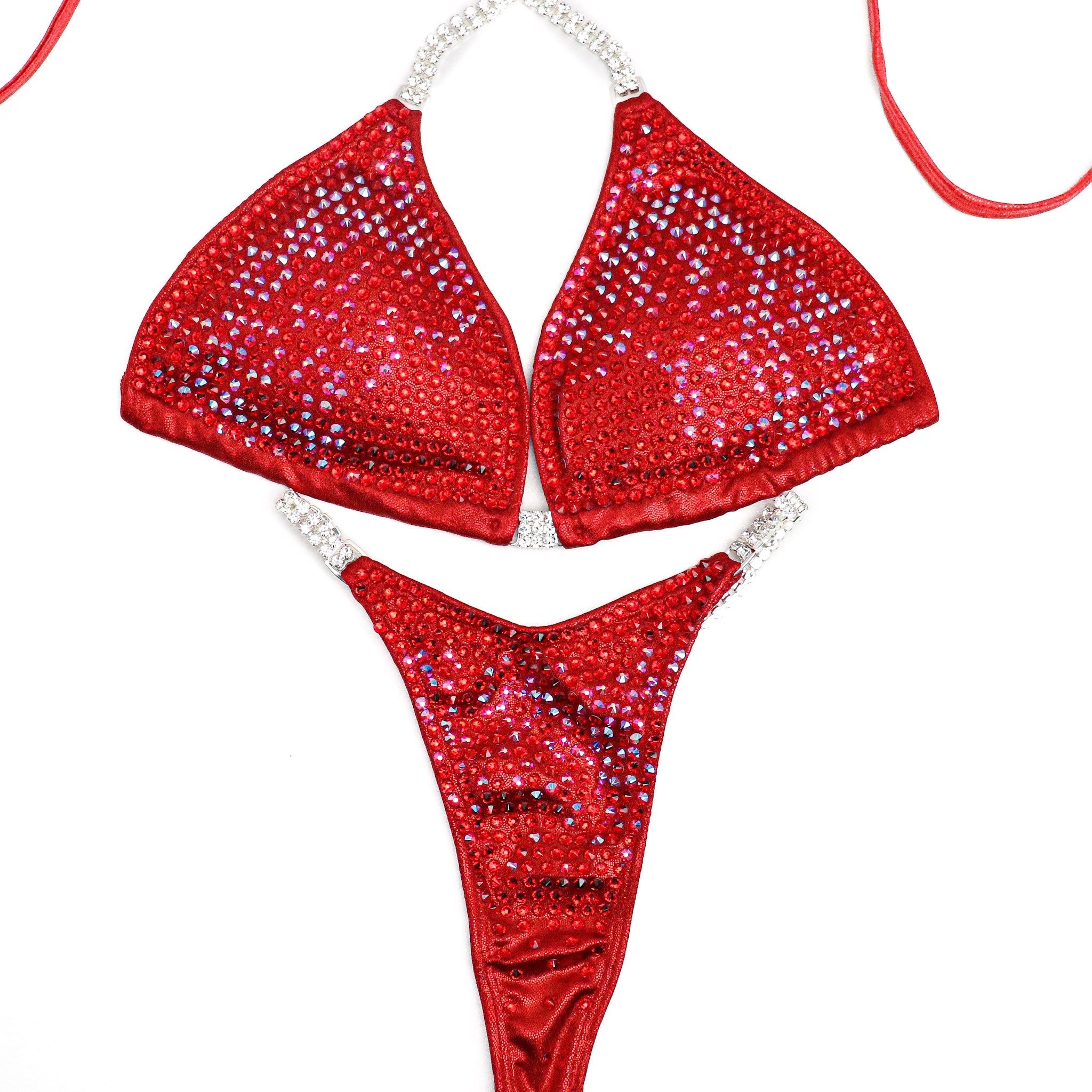 Introducing Ashley K's Cherry Bomb Trinity, inspired by Ashley Kaltwasser's iconic suit at the 2023 Denver Mile High. Radiating with vibrant red hues, this suit ensures you command attention on stage. Elevate your performance with its striking design, a must-have for serious competitors.