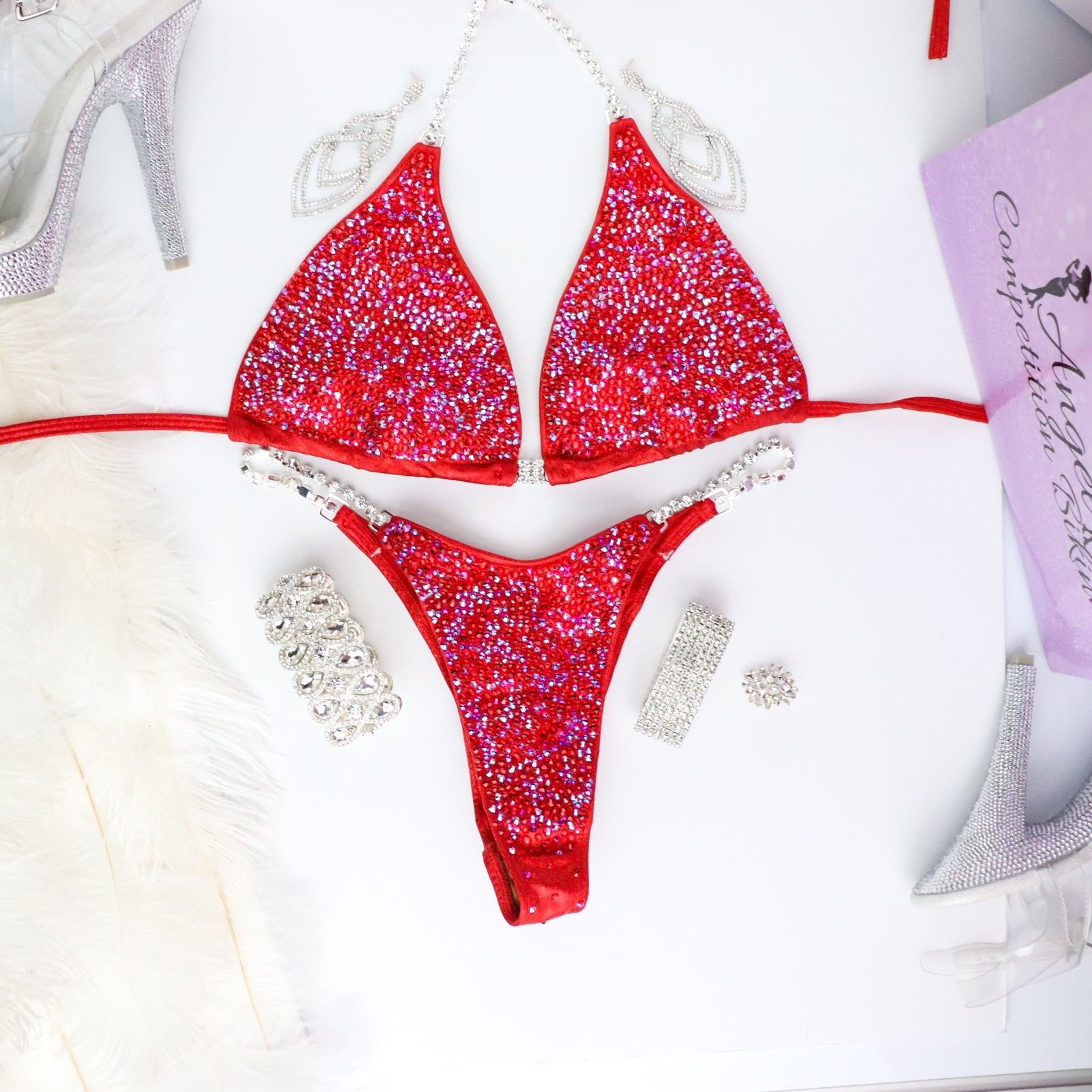 Introducing Ashley's Signature Red 2021 Radiance, a top-selling suit from Angel Competition Bikinis. Inspired by powerful women, it boasts stunning red hues that complement every skin tone and shape. Elevate your stage presence with this timeless and captivating design.