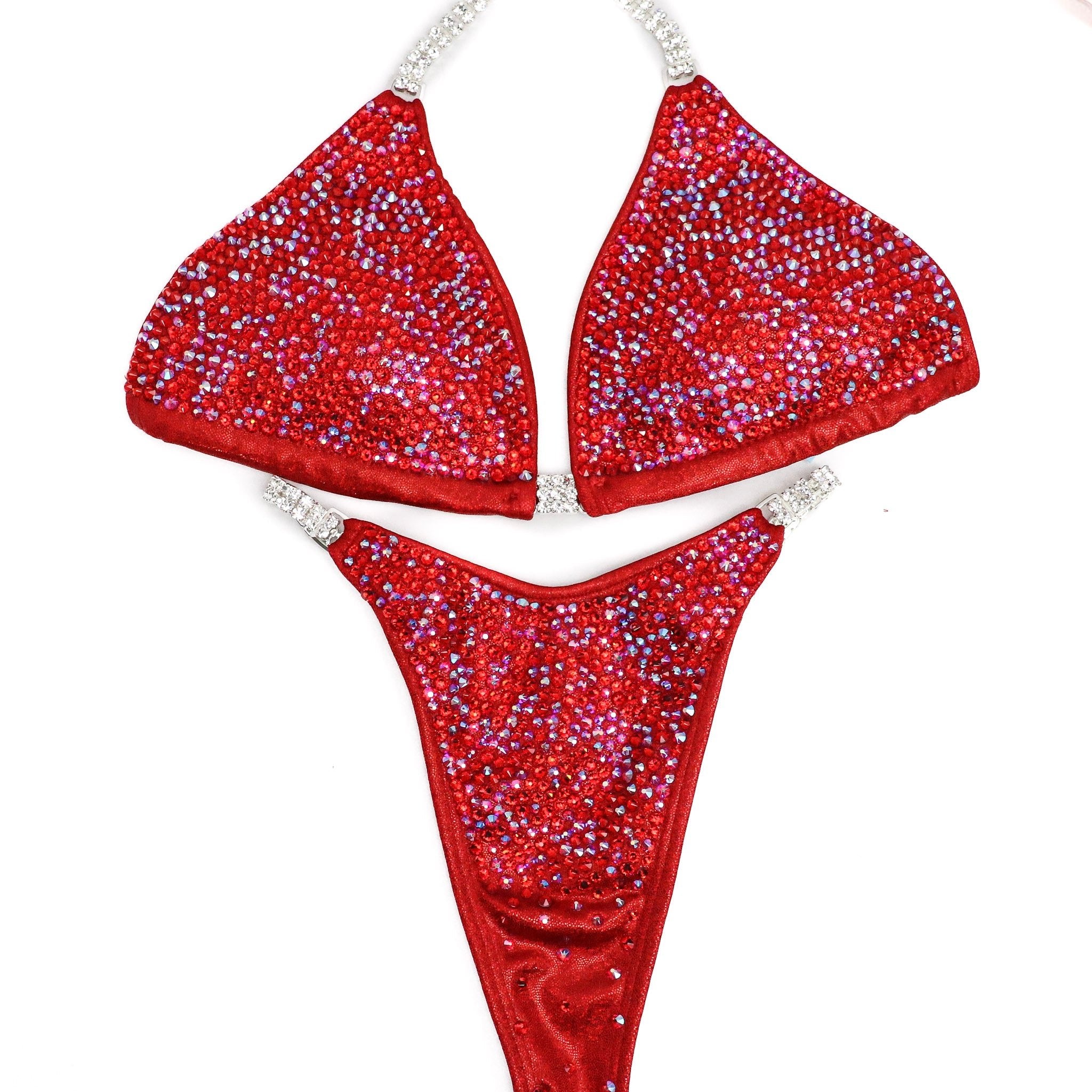 Introducing Ashley's Signature Red 2021 Radiance, a top-selling suit from Angel Competition Bikinis. Inspired by powerful women, it boasts stunning red hues that complement every skin tone and shape. Elevate your stage presence with this timeless and captivating design.