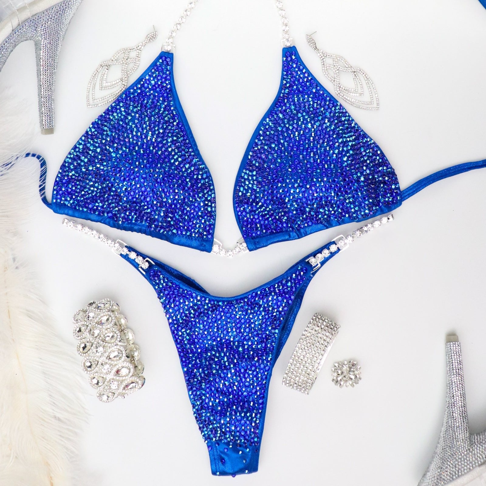 Introducing Cobalt Radiance, the epitome of elegance for female bodybuilding competitors. This shimmering blue suit is designed to light up the stage, igniting your inner confidence. Perfect for all female competitors ready to rock the stage with unparalleled grace and style.