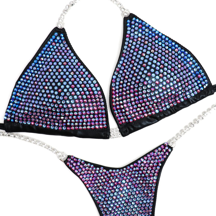 Custom Diamond Trinity bikini with multicolor gradient crystals and rhinestone straps designed for athletes' physique showcase.