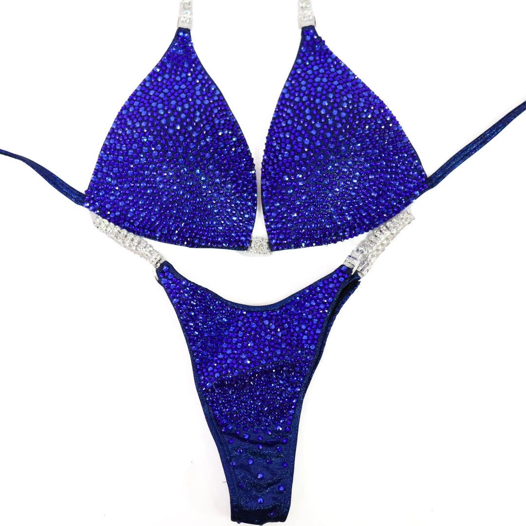 Shine with the Deep Blue Diamond Radiance! A stunning dark blue suit adorned with sapphire crystals for a bold, powerful look. 💎💙 #Bodybuilding #CompetitionSuit #SapphireShine #BlueRadiance