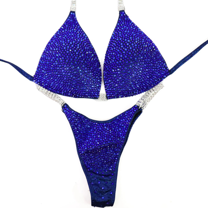 Shine with the Deep Blue Diamond Radiance! A stunning dark blue suit adorned with sapphire crystals for a bold, powerful look. 💎💙 #Bodybuilding #CompetitionSuit #SapphireShine #BlueRadiance