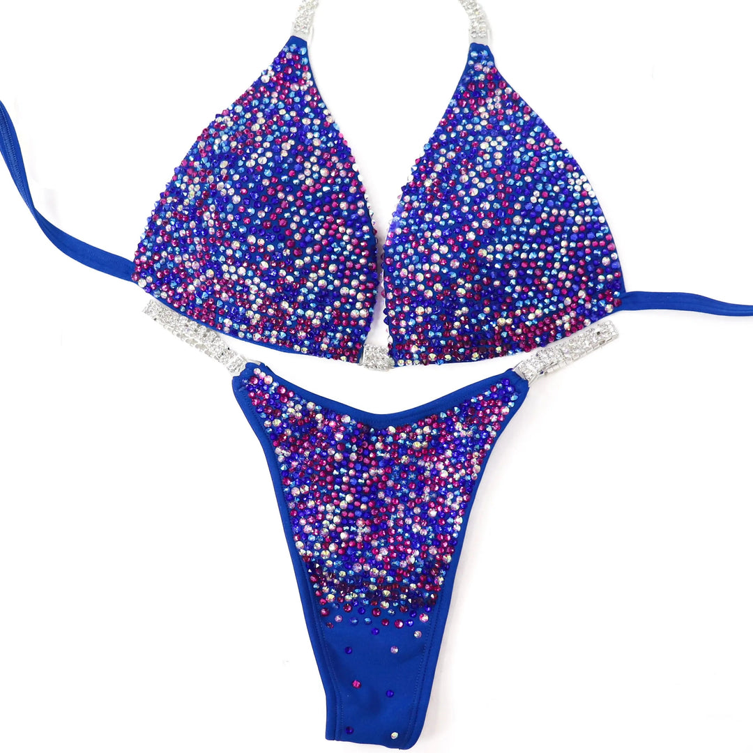 Shine in the Electric Berry Ice Radiance! A matte blue suit with crystal AB & fuchsia pops for a unique, stunning look. 💙✨ #Bodybuilding #CompetitionSuit