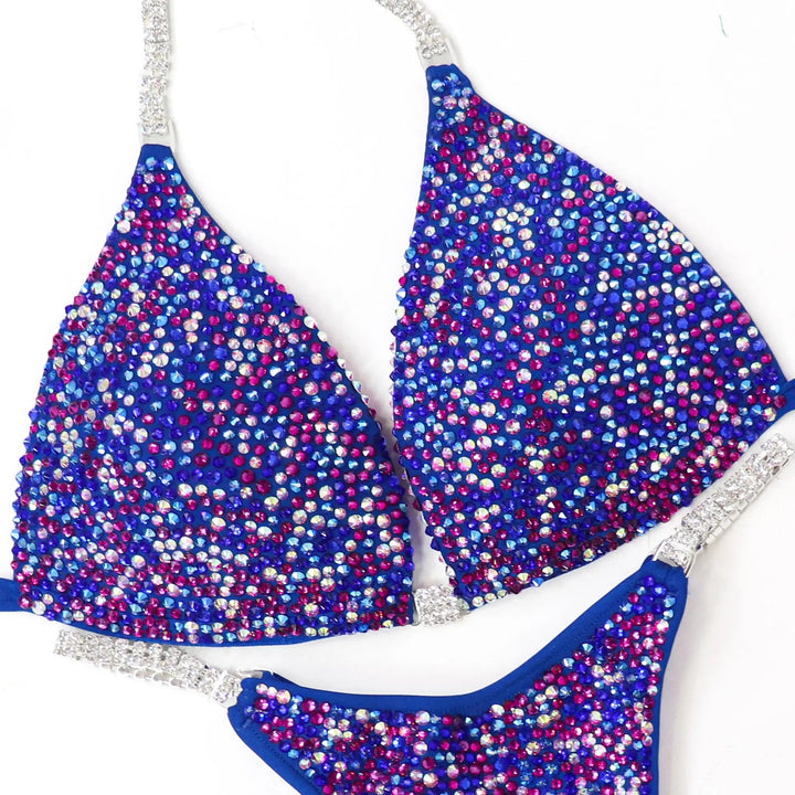 Shine in the Electric Berry Ice Radiance! A matte blue suit with crystal AB & fuchsia pops for a unique, stunning look. 💙✨ #Bodybuilding #CompetitionSuit