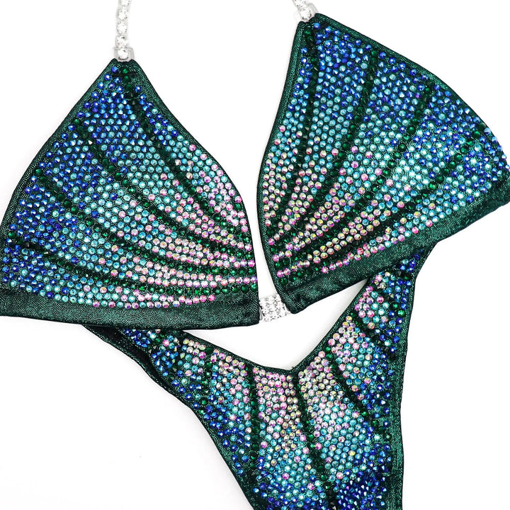 Custom Crystal Galaxy bikini with curved lines and gradient colors adorned with blue and pink crystals for figure competitions.