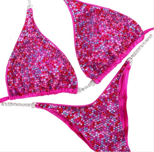 "Introducing the Fuchsia Candy Radiance: crafted on hologram pink, adorned with fuchsias, reds, pinks, and crystal burgundy. This exquisite suit is more than attire; it's a confidence booster, igniting your stage presence with its vibrant charm. Own your moment with radiance! 💖✨ #FemaleBodybuilding #ConfidenceBoost"