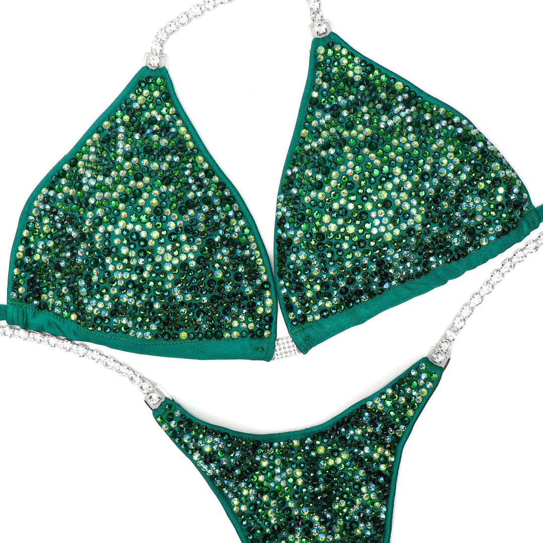 "Introducing Hannah's Lucky Radiance: A captivating blend of light and dark greens, this suit is the ultimate accessory for your competition. Designed to shine bright on stage, it elevates your presence with stunning allure. Step into confidence and command the spotlight! 🍀💫 #FemaleBodybuilding #StagePresence"