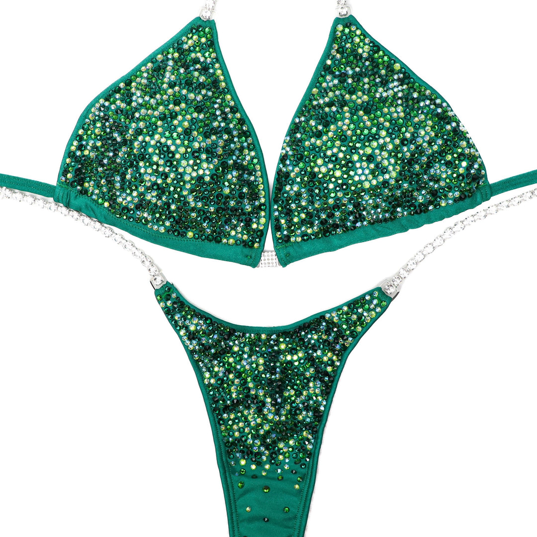 "Introducing Hannah's Lucky Radiance: A captivating blend of light and dark greens, this suit is the ultimate accessory for your competition. Designed to shine bright on stage, it elevates your presence with stunning allure. Step into confidence and command the spotlight! 🍀💫 #FemaleBodybuilding #StagePresence"