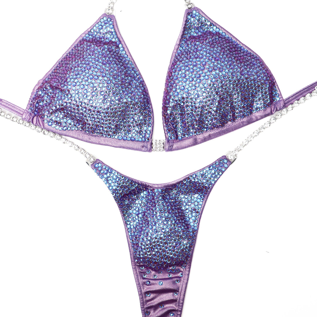 Introducing Lavender Radiance suit, a game-changer for female bodybuilders! 💪✨ With our unique color-changing crystals, this hologram lilac suit transforms into a stunning blend of lavender and burgundy, boosting your confidence and shine on stage! #Bodybuilding #CompetitionSuit #FemaleAthletes 🌟👙