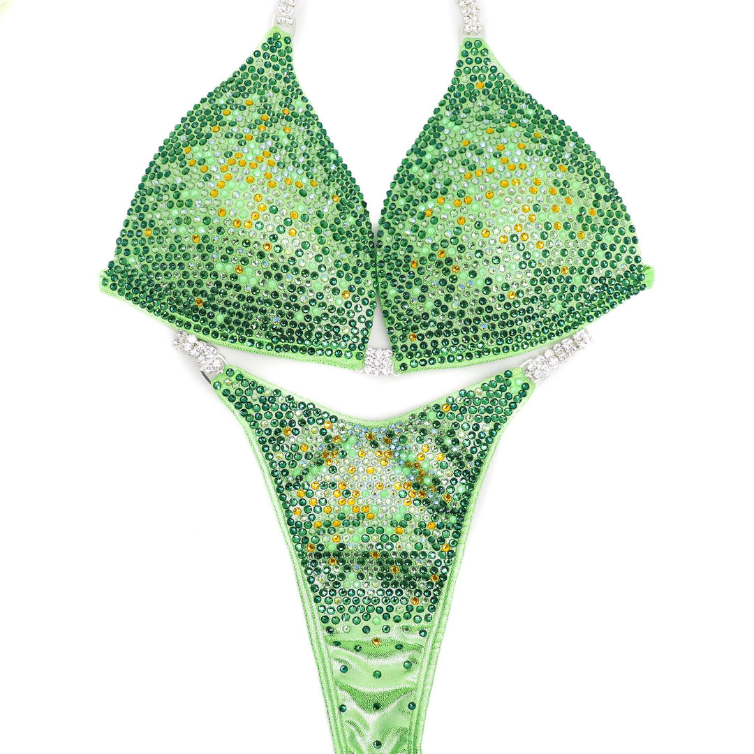 Introducing Lemon Lime Nova, the ultimate lime green suit for female bodybuilders! 💪🍋 Bright and fun, adorned with sprinkles of sunflower, this unique design ensures you stand out on stage. #Bodybuilding #CompetitionSuit #FemaleAthletes 🌟👙