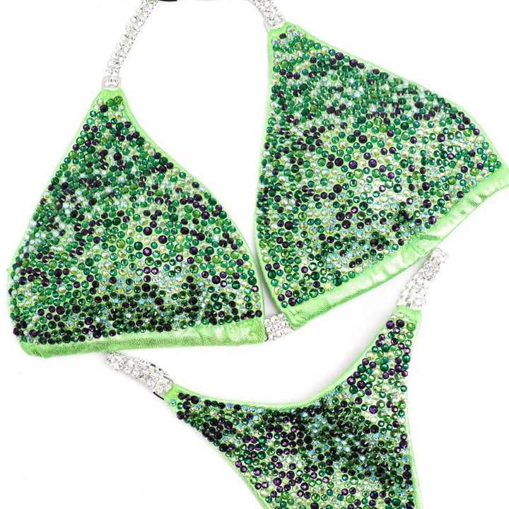 Introducing Lime Storm Radiance 💚🌟, the ultimate competition suit for female bodybuilders! 🏋️‍♀️ Stand out on stage with its vibrant lime hue, sprinkled with hints of violet. Designed to accentuate your physique and command attention, this suit is a must-have for serious competitors. Shine bright with Lime Storm Radiance! #Bodybuilding #CompetitionReady #StagePresence 💪✨