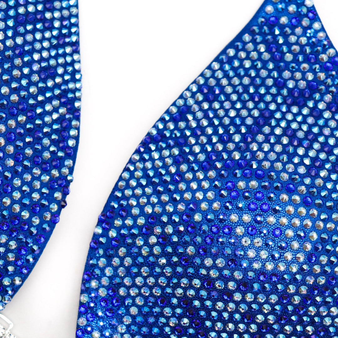 Introducing Lucia's Olympia Bound Multi Color! 💙 Shine bright on stage with this bold blue suit, intricately adorned with shimmering shades of blue crystals. ✨ Designed by Lucia Malavaze, it's your ultimate competition companion! #Bodybuilding #CompetitionSuit #OlympiaBoundMultiColor 💪👗