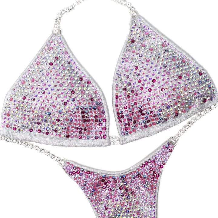 Custom Diamond Trinity bikini with pink and clear crystals in a gradient design for athletes and physique competitions