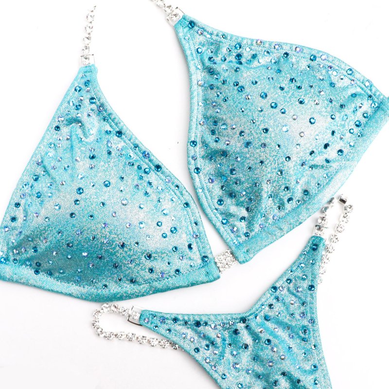 Introducing Ocean Angel Dust 🌊! This aqua jade competition suit for female bodybuilders is simple yet stunning, featuring a scatter of crystals for a sleek look 💫. Shine on stage with elegance and grace! #Bodybuilding #CompetitionSuit #OceanAngelDust 👙💎💙