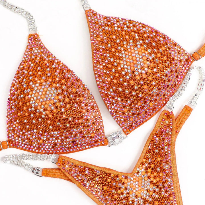 Shine bright in the **Orange Nova** suit! Hologram orange with a stunning gradient of orange crystals & neon accents for a bold, fiery look. 🔥🍊✨ #Bodybuilding #CompetitionSuit #OrangeNova #BoldAndBright