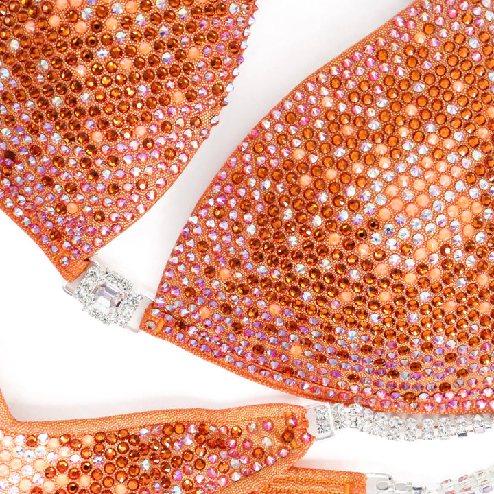 Shine bright in the **Orange Nova** suit! Hologram orange with a stunning gradient of orange crystals & neon accents for a bold, fiery look. 🔥🍊✨ #Bodybuilding #CompetitionSuit #OrangeNova #BoldAndBright