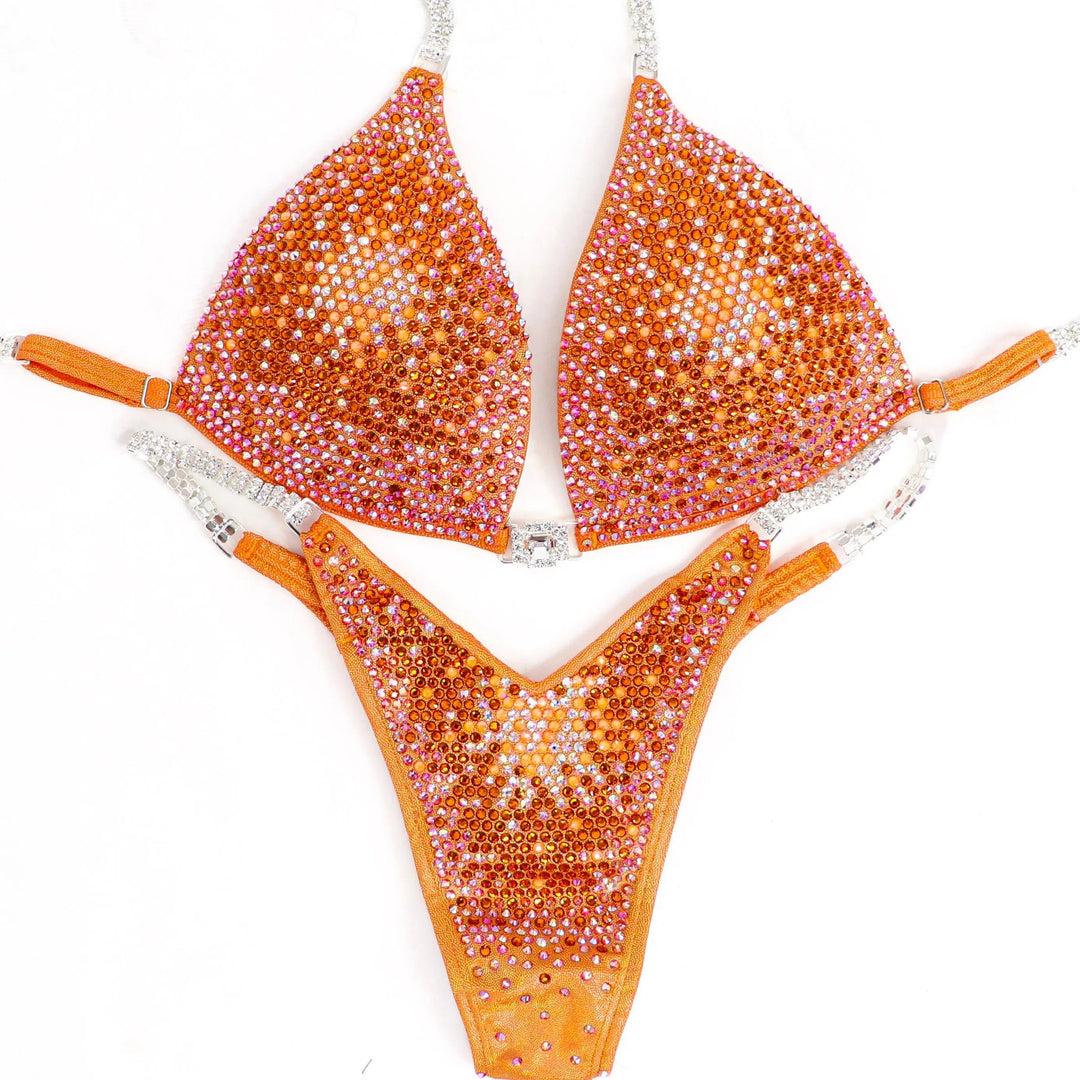 Shine bright in the **Orange Nova** suit! Hologram orange with a stunning gradient of orange crystals & neon accents for a bold, fiery look. 🔥🍊✨ #Bodybuilding #CompetitionSuit #OrangeNova #BoldAndBright