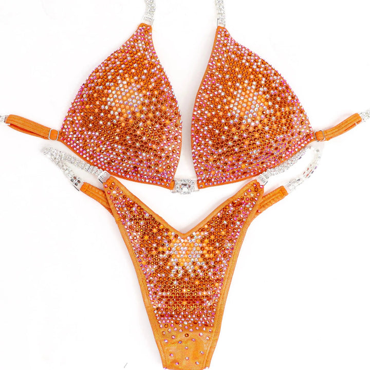 Shine bright in the **Orange Nova** suit! Hologram orange with a stunning gradient of orange crystals & neon accents for a bold, fiery look. 🔥🍊✨ #Bodybuilding #CompetitionSuit #OrangeNova #BoldAndBright