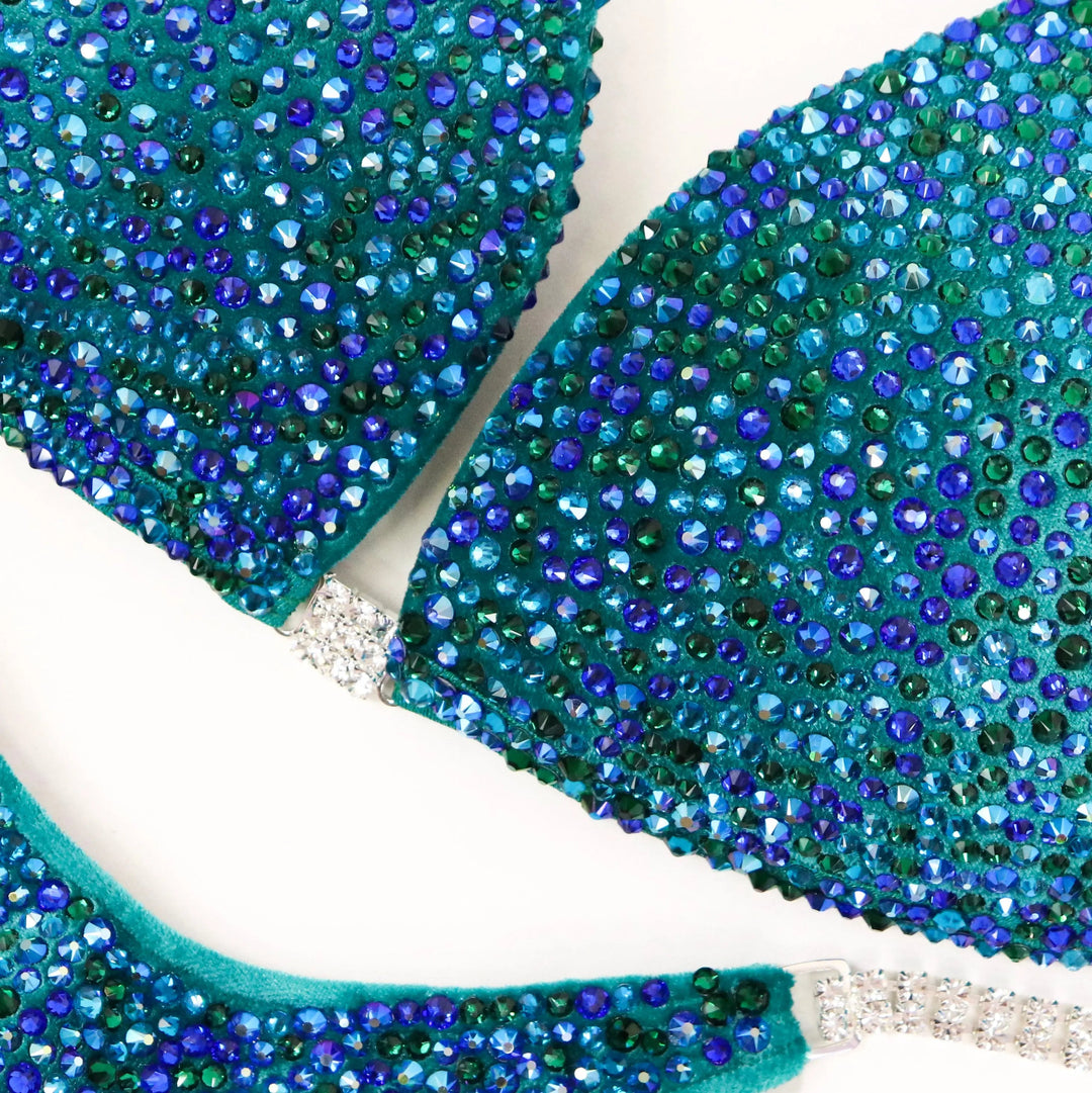 Peacock Velvet Radiance: A stunning velvet teal suit with green and blue crystals, designed to turn heads on stage! 💚💙✨