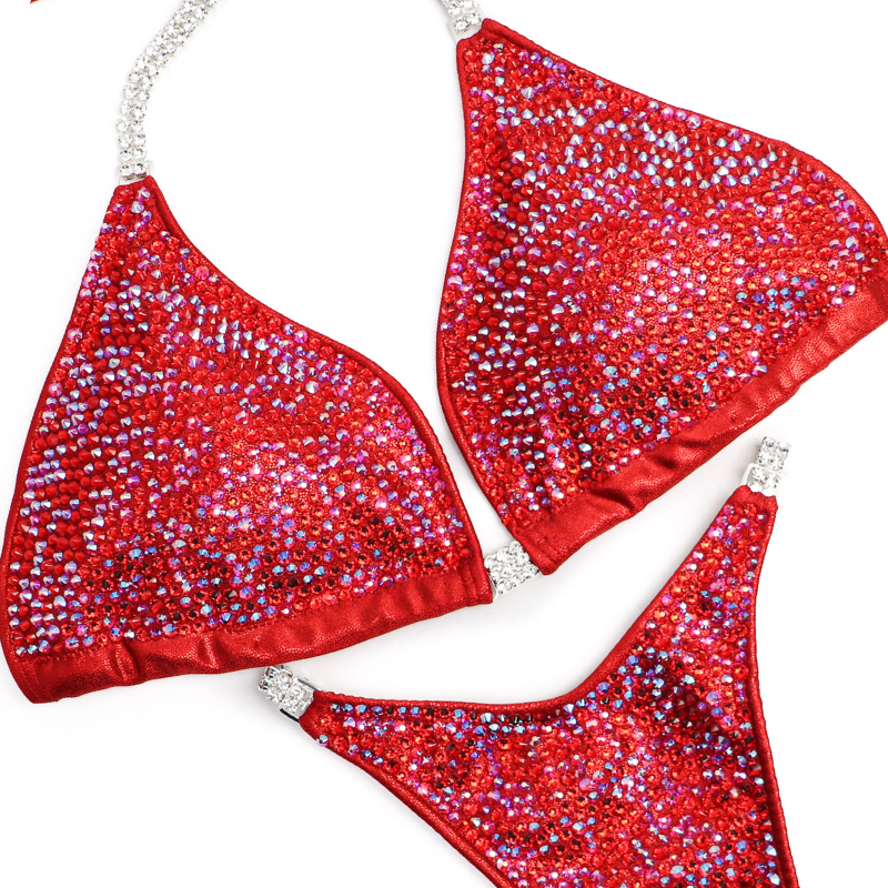 Introducing Ashley's Signature Red 2021 Radiance, a top-selling suit from Angel Competition Bikinis. Inspired by powerful women, it boasts stunning red hues that complement every skin tone and shape. Elevate your stage presence with this timeless and captivating design.