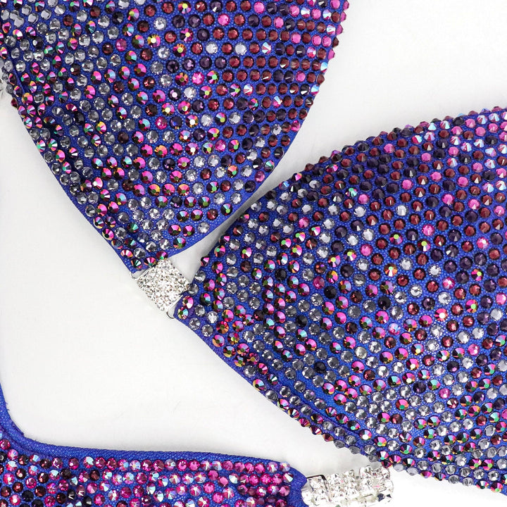 Introducing Purple Party Gradient 💜! This exquisite purple competition suit showcases a stunning gradient of purple and fuchsia crystals, making it truly unique and eye-catching. Stand out on stage with elegance and flair! #Bodybuilding #CompetitionSuit #PurplePartyGradient 👙💎🌟