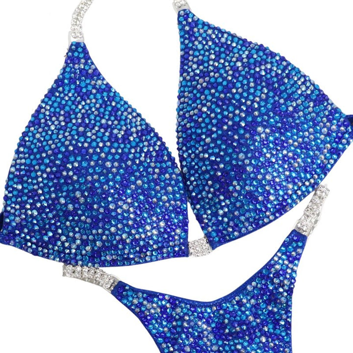 Introducing Rachel's Blue Radiance 💙! This electric blue competition suit features an array of sparkling blue crystals, flattering every skin tone and ensuring you shine like Rachel Schatz on stage. #Bodybuilding #CompetitionSuit #BlueRadiance 💎👙✨