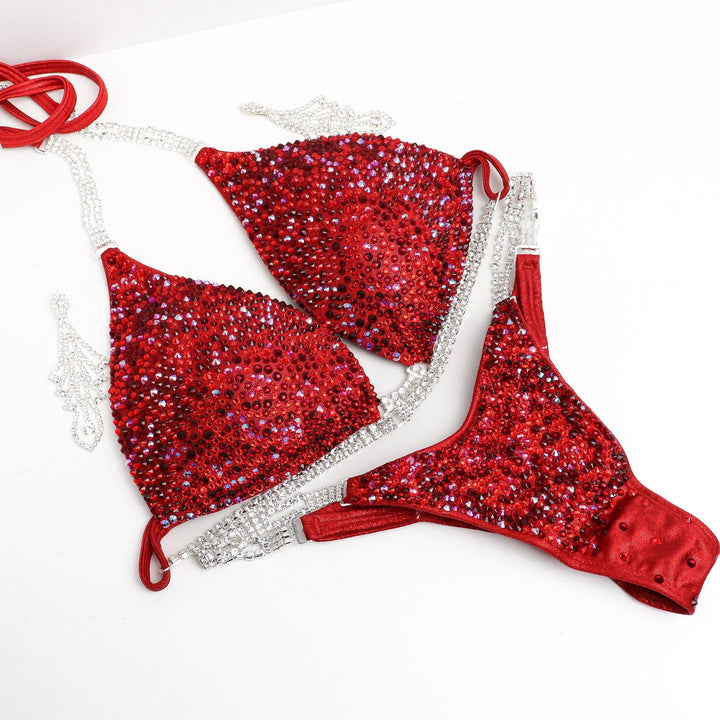 Introducing Razzle Dazzle Red Radiance 💃! A favorite among Angel Competition Bikinis, this suit dazzles with various shades of red crystals, ensuring an unmatched sparkle on stage. Shine bright and stand out! #Bodybuilding #CompetitionSuit #RazzleDazzleRedRadiance 💎👙🌟