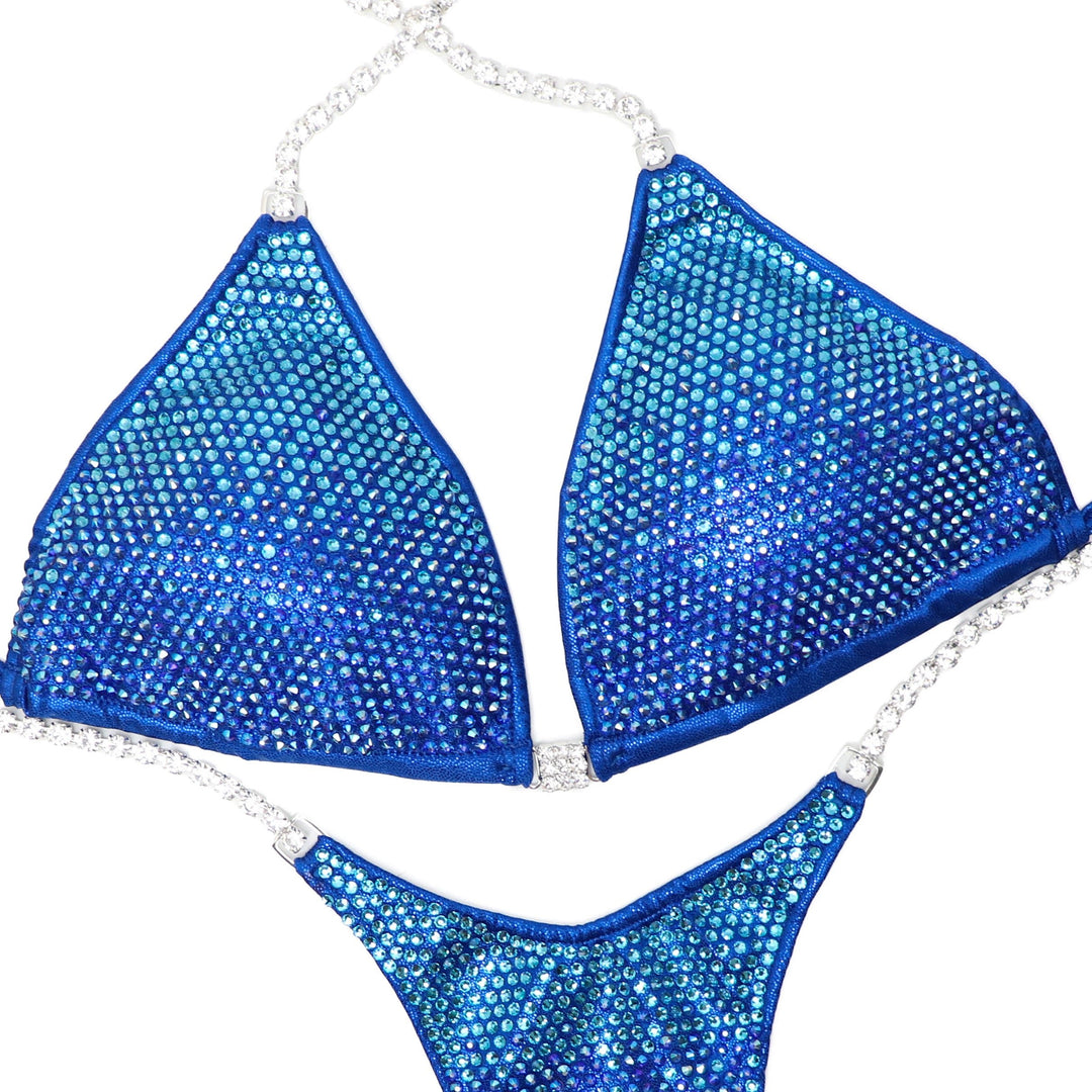 "Introducing Royal Aqua Angel Pro 💪👙 Elevate your stage presence with this electric blue competition suit adorned with dazzling blue and aqua crystals ✨ Shine brighter than ever before! Perfect for female bodybuilders ready to dominate 💎 #Bodybuilding #CompetitionSuit #StageReady #RoyalAquaAngelPro 🏋️‍♀️🔷"