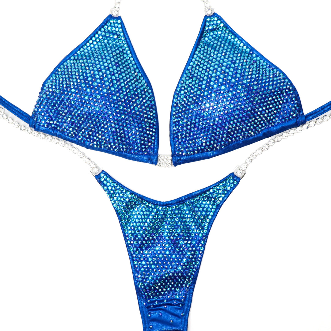 "Introducing Royal Aqua Angel Pro 💪👙 Elevate your stage presence with this electric blue competition suit adorned with dazzling blue and aqua crystals ✨ Shine brighter than ever before! Perfect for female bodybuilders ready to dominate 💎 #Bodybuilding #CompetitionSuit #StageReady #RoyalAquaAngelPro 🏋️‍♀️🔷"