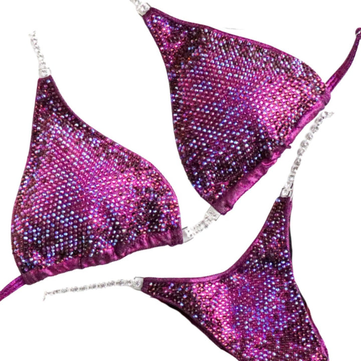 Introducing Savana's Cranberry Nova: a striking cranberry suit adorned with abundant fuchsia crystals and a touch of violet. Designed in collaboration with Savana Sharp, this stunning creation guarantees to dazzle under the stage lights, showcasing your strength and elegance effortlessly. 💎✨ #BodybuildingFashion #CranberryNova #FitnessCompetition