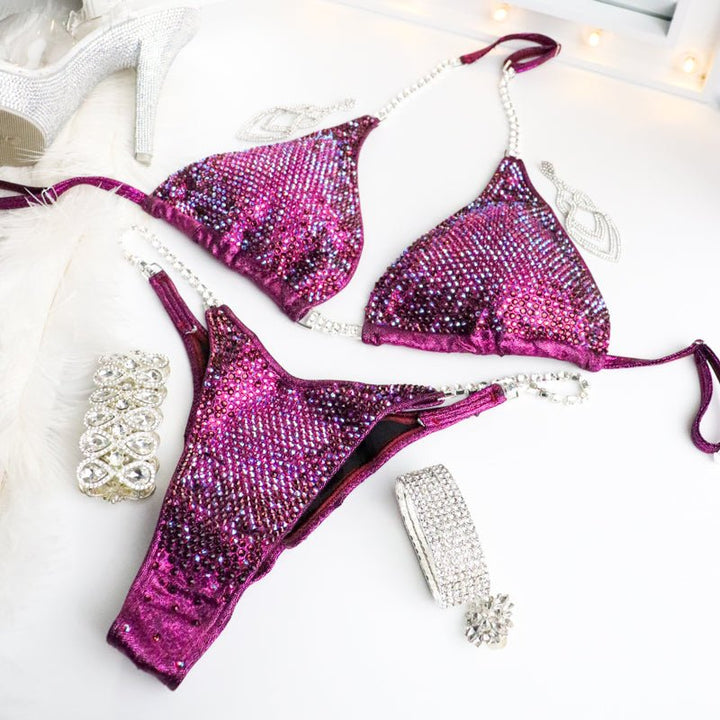 Introducing Savana's Cranberry Nova: a striking cranberry suit adorned with abundant fuchsia crystals and a touch of violet. Designed in collaboration with Savana Sharp, this stunning creation guarantees to dazzle under the stage lights, showcasing your strength and elegance effortlessly. 💎✨ #BodybuildingFashion #CranberryNova #FitnessCompetition