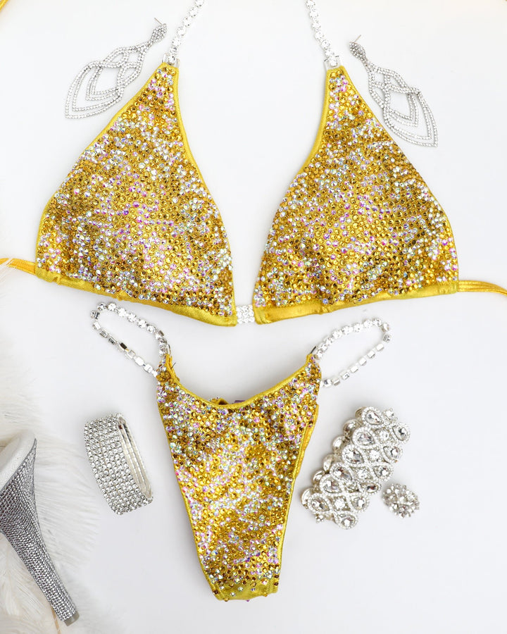 Introducing the Sunflower Radiance competition suit 🌻💎 Elevate your stage presence with this stunning yellow suit adorned with Crystal AB and Sunflower crystals. Designed to shine bright and make a statement, it's perfect for female bodybuilders aiming for elegance and impact. #Bodybuilding #CompetitionSuit #FitnessFashion