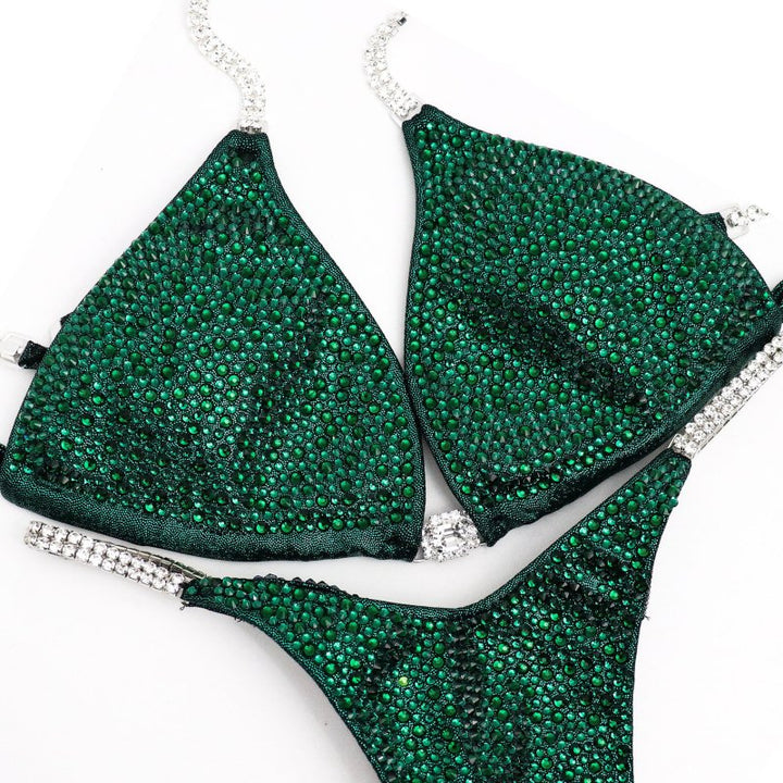 Unveil the True Emerald Radiance: a flawless emerald green competition suit adorned with shimmering Emerald crystals, designed to captivate on stage. Elevate your performance with this stunning piece! 💚💎✨ #Bodybuilding #CompetitionSuit #TrueEmeraldRadiance #EmeraldCrystals