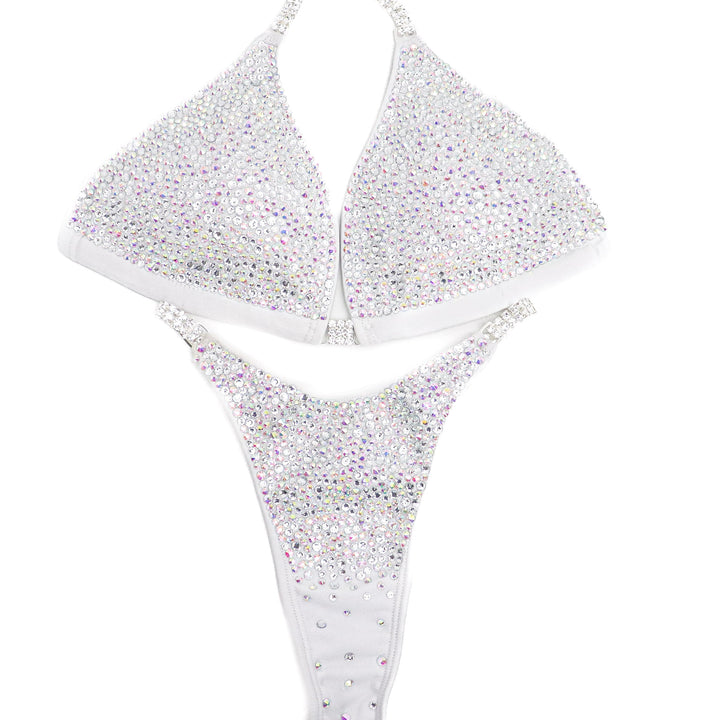 Introducing White Goddess Radiance: a Matte White competition suit adorned with Crystal Clear and Crystal AB crystals, creating an angelic and elegant look perfect for the stage! ✨👼 Stand out with grace and confidence in this stunning ensemble. #BodybuildingSuit #CompetitionReady #WhiteGoddessRadiance